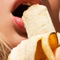 Woman eating a banana, a great food with prebiotics