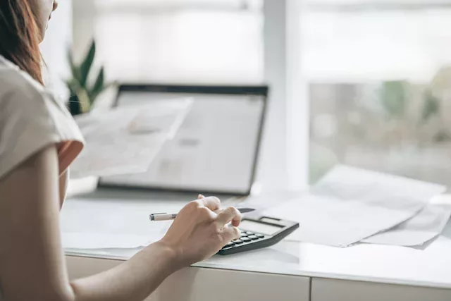 Woman getting her money in order by following financial wellness tips