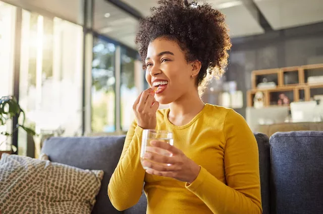 Woman taking a selenium supplement