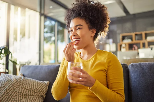 Woman taking a selenium supplement