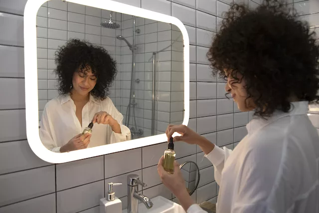 Woman applying acne-fighting products during her skincare routine