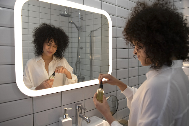 Woman applying acne-fighting products during her skincare routine