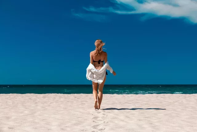 Woman in bathing suit hiding her bottom because of butt acne