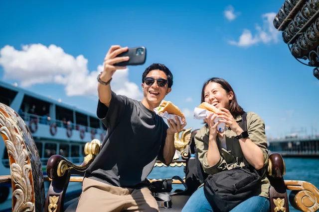 Tourists taking photo while traveling and enjoying healthy local food