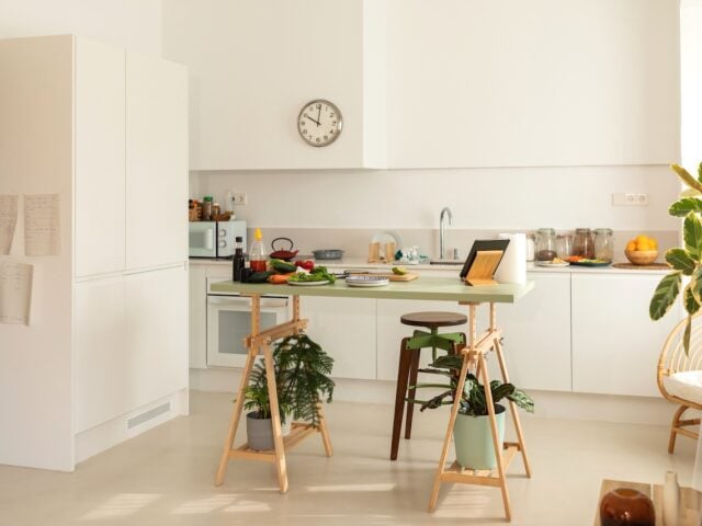 Empty kitchen with clock to demonstrate health benefits of fasting